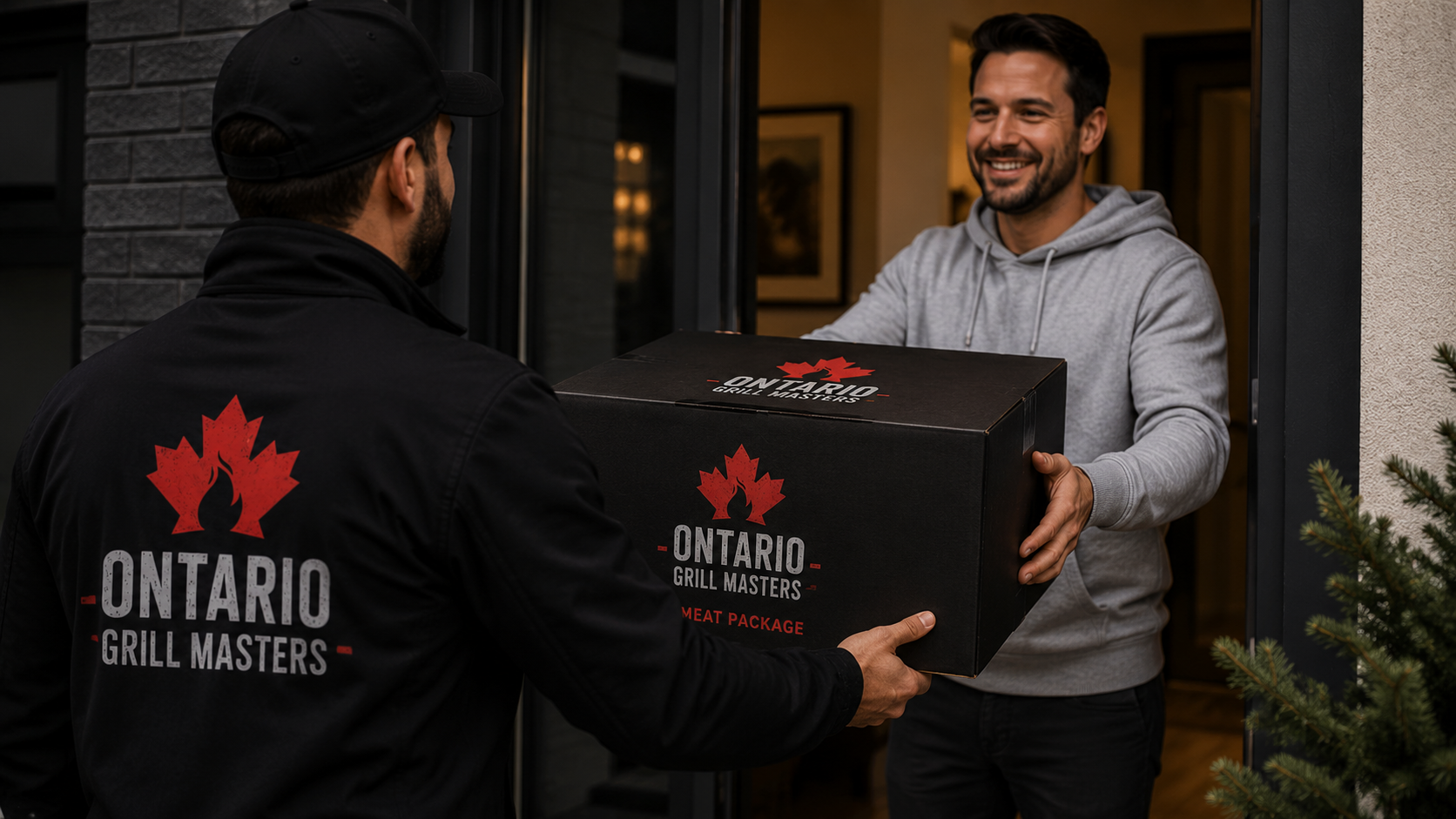 Two men exchange a black “Ontario Grill Masters” meat package box at a warmly lit doorway.